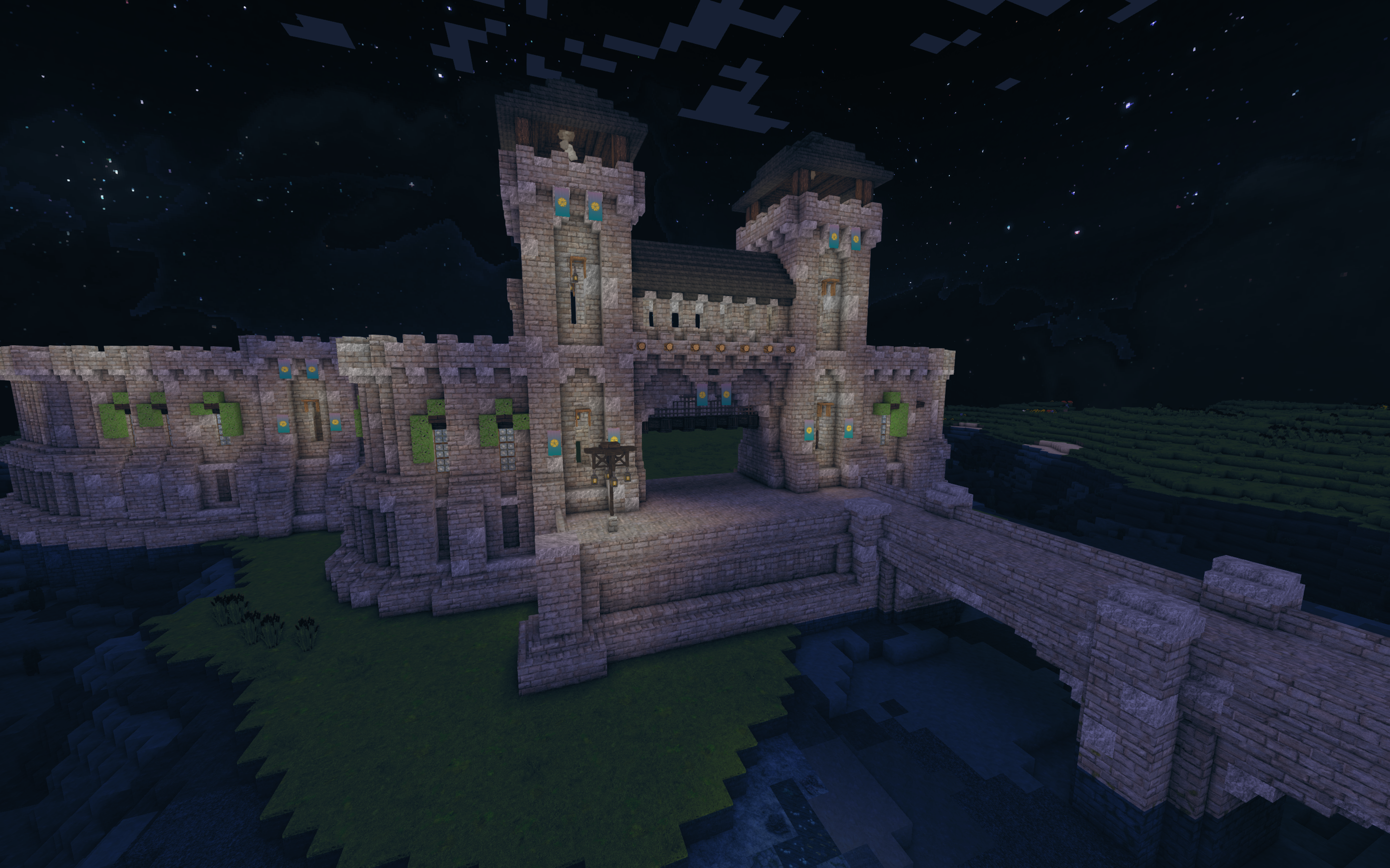 An arial view of the castle wall entrance at night.